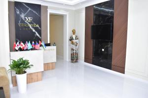 a room with a statue of a mannequin and a television at Veranda XF Hotel in Samarkand