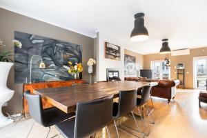 a dining room with a large wooden table and chairs at Exquisite Townhouse in Lisbon City Center- PRIVATE GARAGE & TERRACE in Lisbon