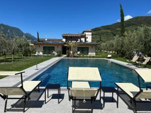 a villa with a swimming pool and a house at Casa Maria Apartments in Riva del Garda