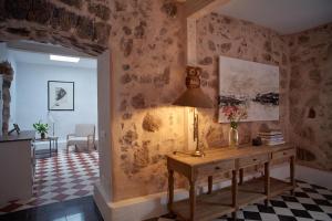 a room with a table and a lamp on a wall at UNIQUE Homes Lajares - adults only in Lajares +32 photos