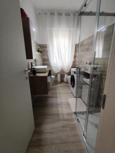 a bathroom with a glass shower and a sink at Casa Ezio beach&relax in Chioggia +42 photos