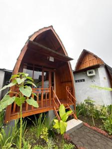 a round house with a porch and a building at Pondok Kebun Sayur in Bedugul +16 photos