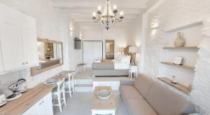 a living room with a couch and a bedroom at TOP SUITES in Ermoupoli