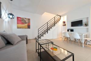 a living room with a couch and a table at Votsalo Suites in Skala Potamias