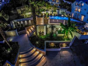 an aerial view of a building with a swimming pool at night at Apartments Secret Garden in Ulcinj