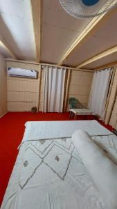 a room with two beds and a red floor at Keyangjhiri Eco Resort, Lama, Bandarban in Bāndarban