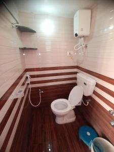 a small bathroom with a toilet and a sink at Swami's Yatri nivas in Akalkot