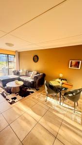 a living room with a couch and a table at 2 Bedrooom Self Catering Unit, East London, 5241, South Africa, KuGompo City in Dorchester Heights 