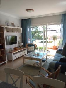a living room with a couch and a table at Elviria Beauty by the sea in Marbella
