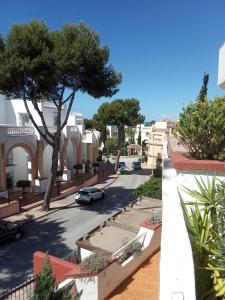 a view of a street with a tree and buildings at Elviria Beauty by the sea in Marbella