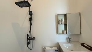 a shower in a bathroom with a camera on the wall at Resort Hoa Loi in Vĩnh Cửu Lỏi (1)