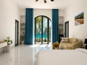 a bedroom with a large bed and a living room at Resort Hoa Loi in Vĩnh Cửu Lỏi (1)
