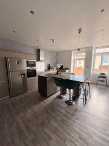 a kitchen with a table and a counter top at Maison Spacieuse 3 chambres, billard, proche Zénith, in Pérignat-lès-Sarliève