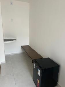 a wooden bench sitting next to a black box at Villa Marechais in Marechal Deodoro