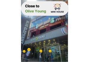 a sign that reads close to olive young min house at Mini House in Busan