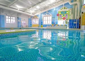 a swimming pool in a building with a large pool at Unity Skirlington Coast Yorkshire in Ulrome +26 photos