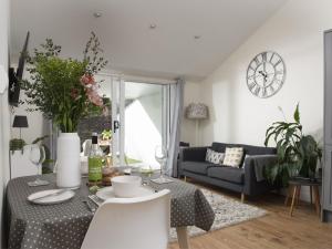 a living room with a table and a couch at Little Dunley Cottages - Hazel in Bovey Tracey