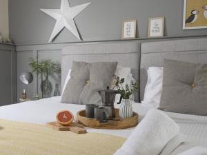 a bed with a tray with a fruit on it at Little Dunley Cottages - Hazel in Bovey Tracey +3 photos