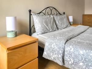 a bedroom with a bed and a dresser with a lamp at Old Barn Cottage - Uk47144 in Glasgow