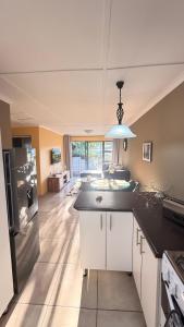 a kitchen with a large island in a room at 2 Bedrooom Self Catering Unit, East London, 5241, South Africa, KuGompo City in Dorchester Heights 