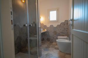 a bathroom with a shower and a toilet and a sink at Villa Rosa in Budoni +17 photos