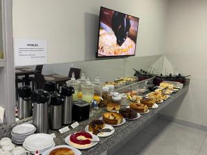 a buffet line with many different types of pastries at Carmo Palace Hotel in Carmo do Paranaíba