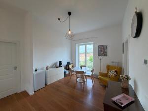 a living room with a table and a yellow couch at Terrazza Vanvitelli in Caserta