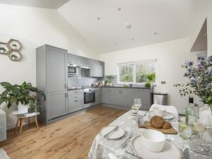 a kitchen with a table with a plate of food on it at Little Dunley Cottages - Willow in Bovey Tracey