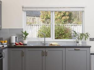 a kitchen with a sink and a window at Little Dunley Cottages - Maple in Bovey Tracey