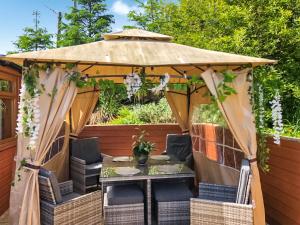 a gazebo with a table and chairs under it at Cow Boy Cabin - Uk47145 in Glasgow