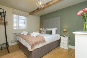 a bedroom with a large bed with towels on it at The Moorings in St Ives