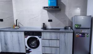 a kitchen with a sink and a washing machine at Danzha Hotel 1 in Erbil +7 photos