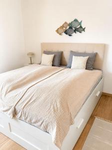 a bed with a white bed frame in a bedroom at Apartment ALBA in Medulin