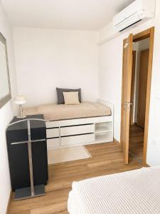 a small bedroom with a bed and a window at Apartment ALBA in Medulin +4 photos