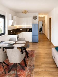 a kitchen and living room with a table and chairs at Apartment ALBA in Medulin