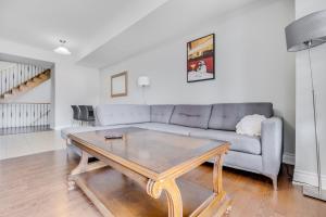 a living room with a couch and a coffee table at Spacious Bright Private! Townhome in Markham in Markham