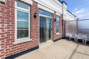 a patio with chairs and windows on a brick building at Spacious Bright Private! Townhome in Markham in Markham
