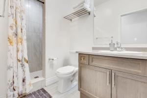 a bathroom with a toilet and a sink and a shower at Spacious Bright Private! Townhome in Markham in Markham +20 photos