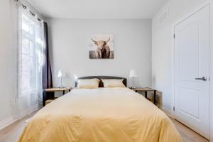 a bedroom with a large bed with yellow sheets at Spacious Bright Private! Townhome in Markham in Markham