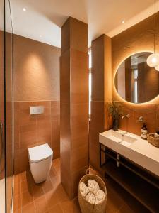 a bathroom with a toilet and a sink and a mirror at Beach Hotel Terracotta in Sapri