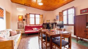 a living room with a table and a couch at Torre del Pozzo Seaview Retreat Sunset Terrace in S'archittu Cuglieri