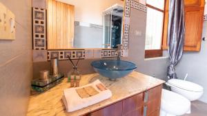 a bathroom with a bowl sink and a toilet at Torre del Pozzo Seaview Retreat Sunset Terrace in S'archittu Cuglieri +54 photos