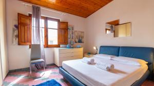 a bedroom with a bed with towels on it at Torre del Pozzo Seaview Retreat Sunset Terrace in S'archittu Cuglieri