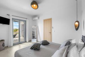 a bedroom with a bed with two pillows on it at Juniper View in Aspro Chorio Paros