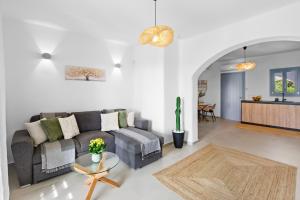 a living room with a couch and a table at Juniper View in Aspro Chorio Paros