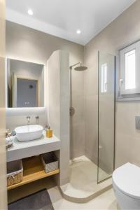 a bathroom with a toilet and a sink and a shower at Juniper View in Aspro Chorio Paros +16 photos