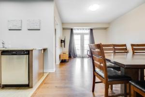 a kitchen and dining room with a table and chairs at spacious 3 bedroom space in Markham