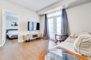 a living room with a couch and a tv at spacious 3 bedroom space in Markham