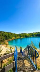 a blue staircase leading down to a lake at Campingfass Zur Adria in Großdubrau
