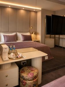 ein Hotelzimmer mit einem Bett mit einem Tisch und einem Tisch in der Unterkunft Spa Hotel Ezeretz Blagoevgrad in Blagoewgrad